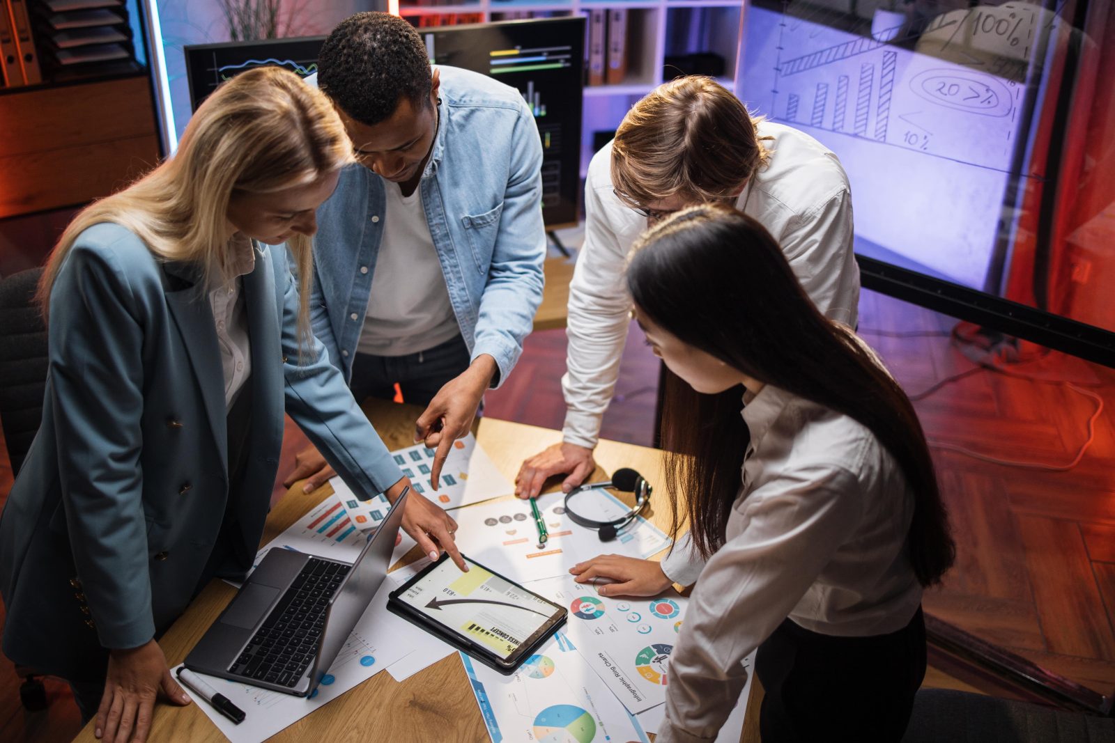 Multiracial business partners analyzing graphs together